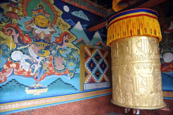 Large prayer wheel at the entrance to Punakha Dzong