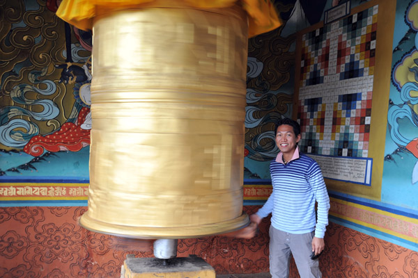 Always spin the prayer wheel clockwise, the same direction that you should circumambulate Buddhist temples