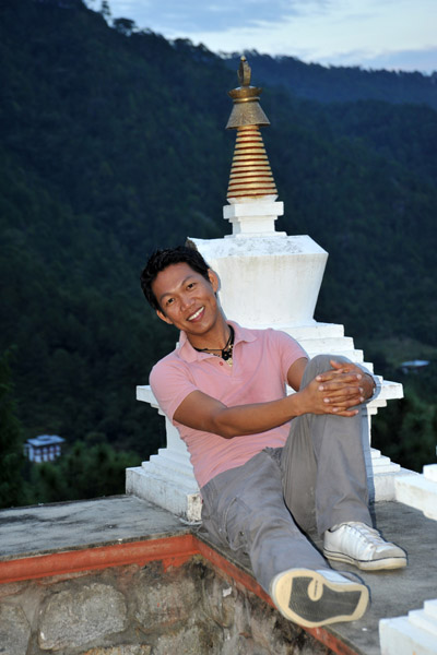 Dennis leaning against one of the small stupa shaped decorations