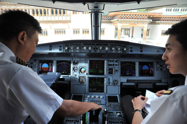Captain and his young First Officer preparing their A319 for departure from Paro Airport