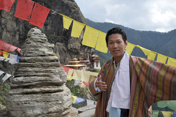 Putting on the gho, the traditional robe of Bhutan