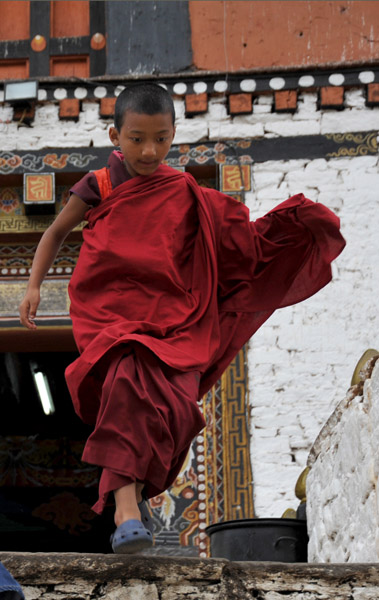A young novice monk in a hurry 
