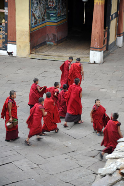 Monks passing through the courtyard, Paro Dzong
