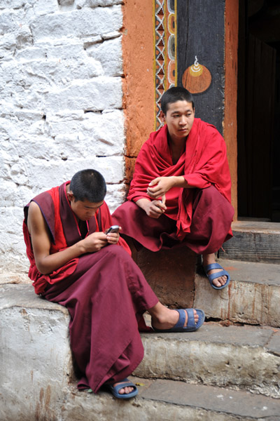 Monk texting, Paro Dzong