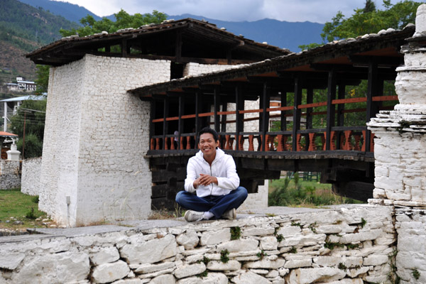 Dennis and the cantilevered bridge at Paro Dzong