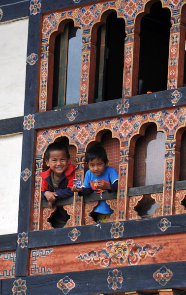 Two small boys in the lower part of a window