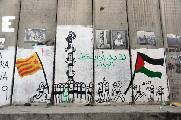 West Bank Separation Wall graffiti - Running flags and standing on shoulders