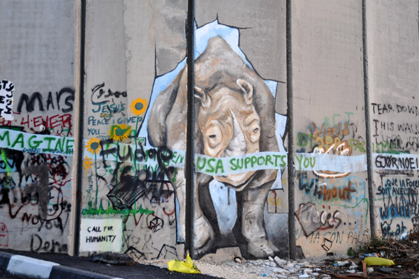 West Bank Separation Wall graffiti - Rhino breaking through the wall