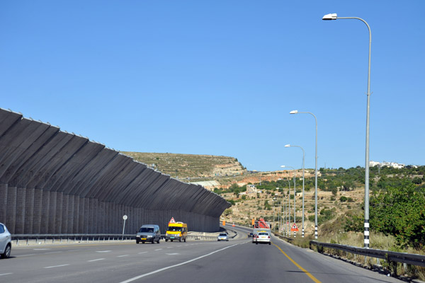 Hwy 60 with a large overhanging section of the West Bank Separation Wall  to deter Palestinian stone throwers from Bayt Jala