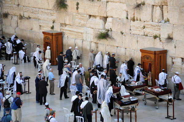 Men praying at the Western Wall, the most sacred site in Judaism