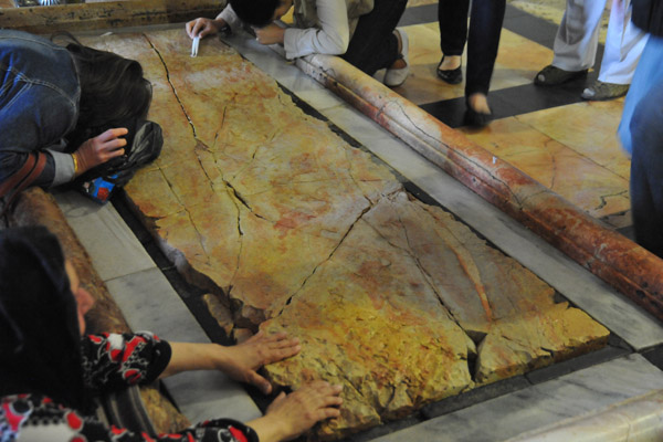 Pilgrims touching the Stone of Unction (Stone of Anointing), Church of the Holy Sepulchre
