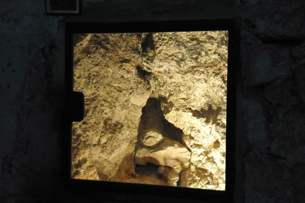 Crack in the Rock of Golgotha through a viewing window, Chapel of Adam
