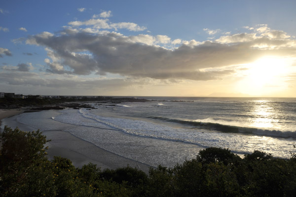 Sunset at Rooielsbaai with Cape Point visible in the distance across False Bay