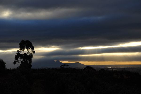 Rays of sun shining through the clouds with Lion's Head in Cape Town visible