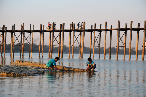 Boys playing on the edge of the lake by the Teak Bridge, Amarapura