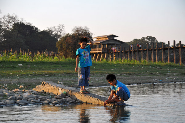 Boys playing on the edge of the lake by the Teak Bridge, Amarapura