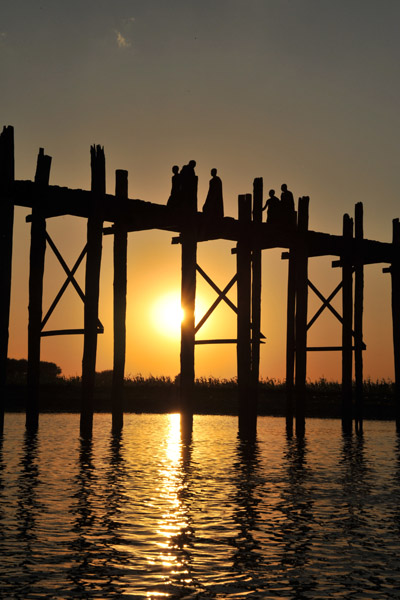 Villagers crossing the Teak Bridge at sunset, Amarapura