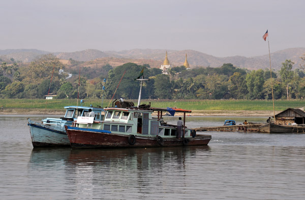 A pair of boats rafted together in front of Mingun
