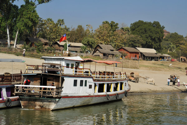 Boats pulled up along the sandy waterfront at Mingun