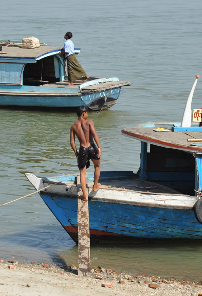 Boy boarding a boat by gangplank