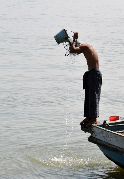 Boatmen bathing with buckets of Irrawaddy River water