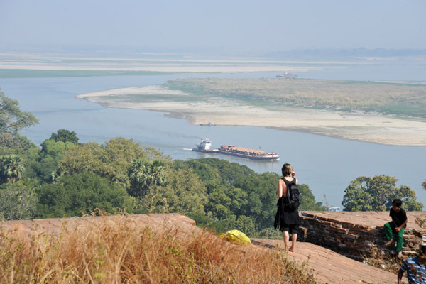 Barge loaded with timber logs coming down the Irrawaddy River