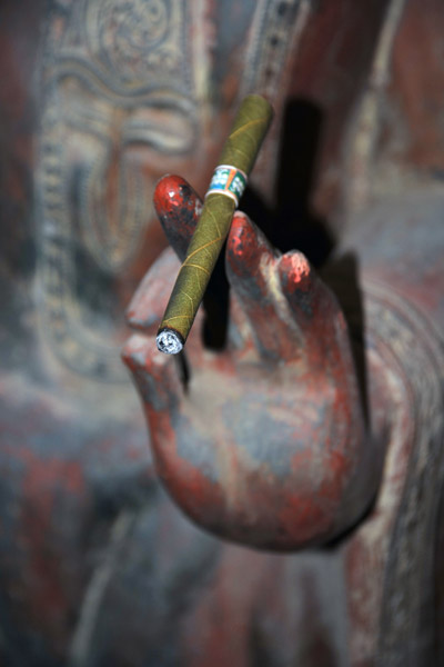 ...the salesman discreetly handed his cheroot to Buddha