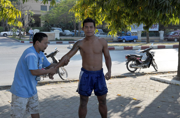 Burmese boxer training along the moat of Mandalay Palace