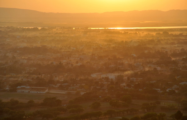 The city of Mandalay with the sun reflecting off the Irrawaddy (Ayeyarwady) River