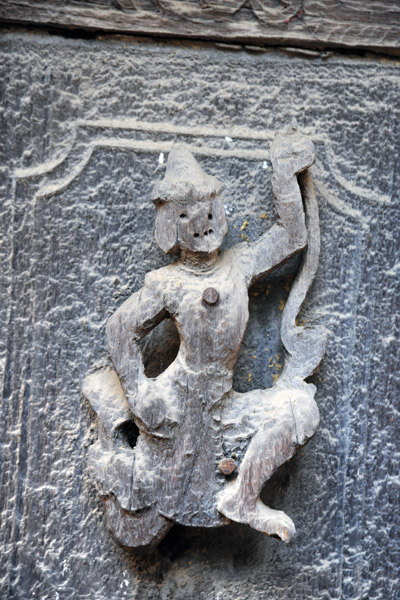 Badly weathered exterior carving