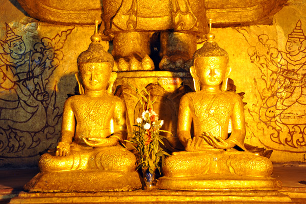 Smaller Buddha statues at the feet of the colossal Gautama