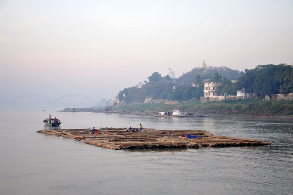 Large bamboo raft being towed down the Irrawaddy River past Sagaing