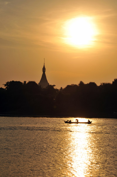 Inwa stupa with the early morning sun and boat