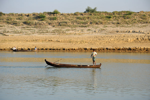 Burmese fisherman pulling in his net