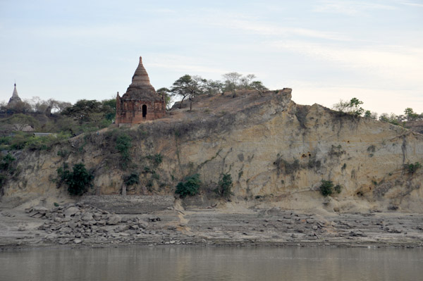 Red brick stupa on a sandy cliff by Nyaung U, the edge of the Bagan Archeological area