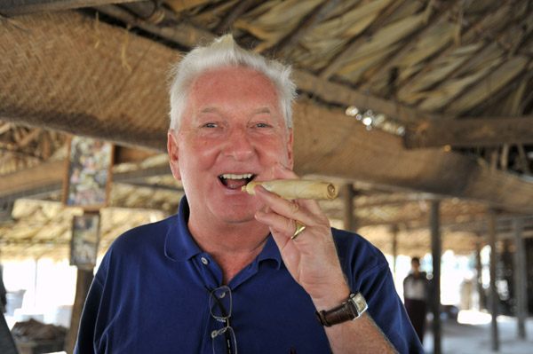 Tourist smoking a large handmade Burmese cigar
