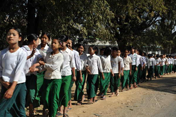 Long line of Burmese schoolgirls walking in Shwengaung