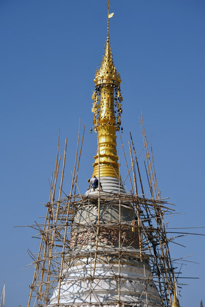 Workman on top of a stupa