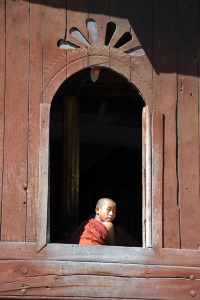 Monk sitting in a window of Shwe Yan Pyay