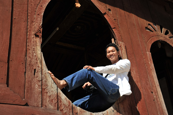Dennis sitting in one of the famous oval windows of Shwe Yan Pyay monastery