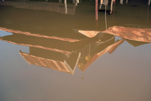 Reflection in the brown water of Inle Lake