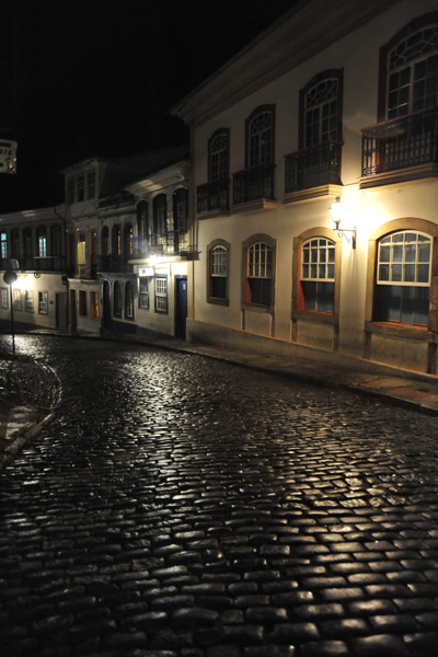 Light shining off Ouro Preto's cobblestone street at night