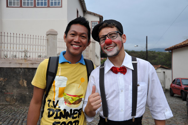 A young actor recruiting spectators for tonights performance, but some how comedy in Portuguese - probably not a good idea