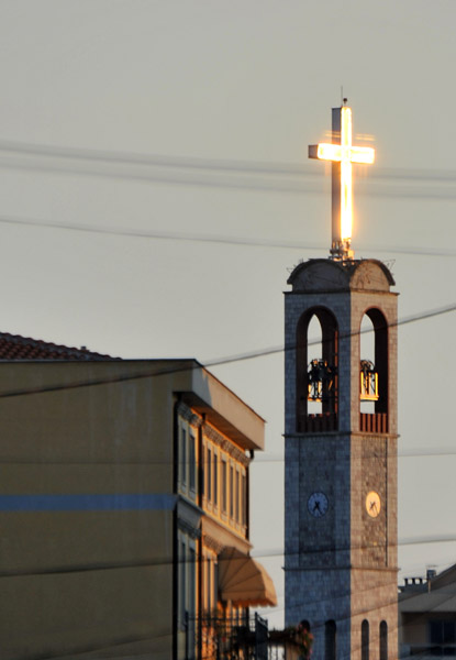 Late afternoon sun shining on the golden cross of the Franciscan Church