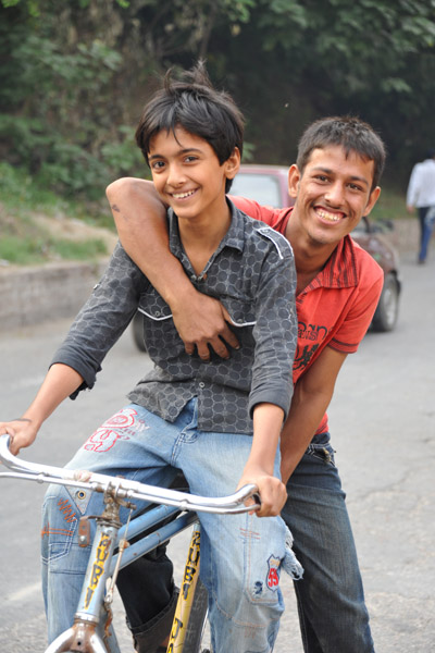 A pair of boys sharing a bike, Lahore