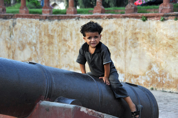 Boy posing on a cannon, Lahore Fort