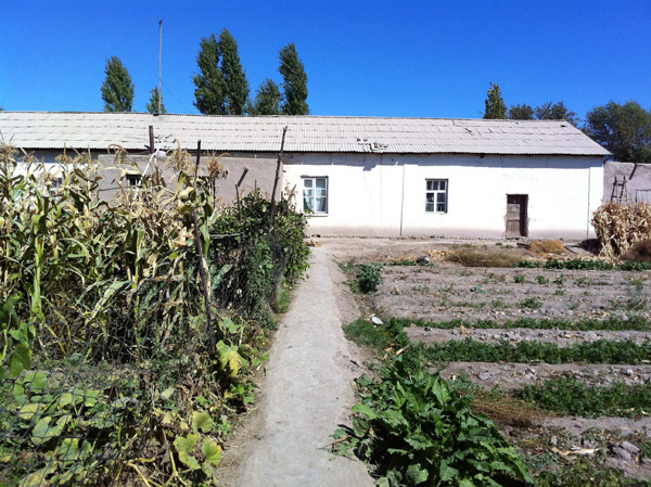 The simple house of the guide's family with large garden in the rear