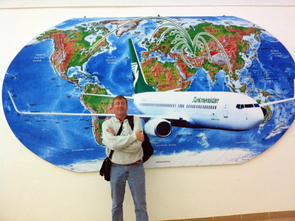 Me at Dashoguz Airport in front of a map of the Turkmenistan Airlines route structure