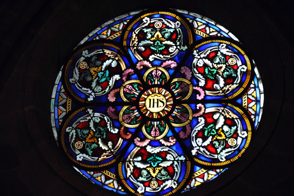 Round stained glass window with the Christogram IHS, St. Peter's Cathedral, Geneva