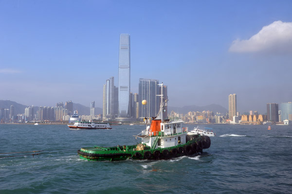 Tugboat in front of the growing skyline of Kowloon